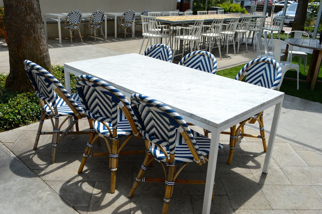 white marble table and blue french chairs, local river oaks houston