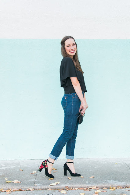 Black Lace & Embroidered Heels featured by top Houston fashion blog, Lone Star Looking Glass: image of a woman wearing Henri Bendel clutch, anthropologie embroidered heels, MIH jeans and Francesca’s Black lace Blouse