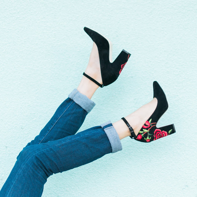anthropologie black and embroidered heels, anthropologie billy ella heels, black heels with red embroidery, billy ella velvet varlan heels, anthropologie varlan heels Black Lace & Embroidered Heels featured by top Houston fashion blog, Lone Star Looking Glass: image of a woman wearing Henri Bendel clutch, anthropologie embroidered heels, MIH jeans and Francesca’s Black lace Blouse