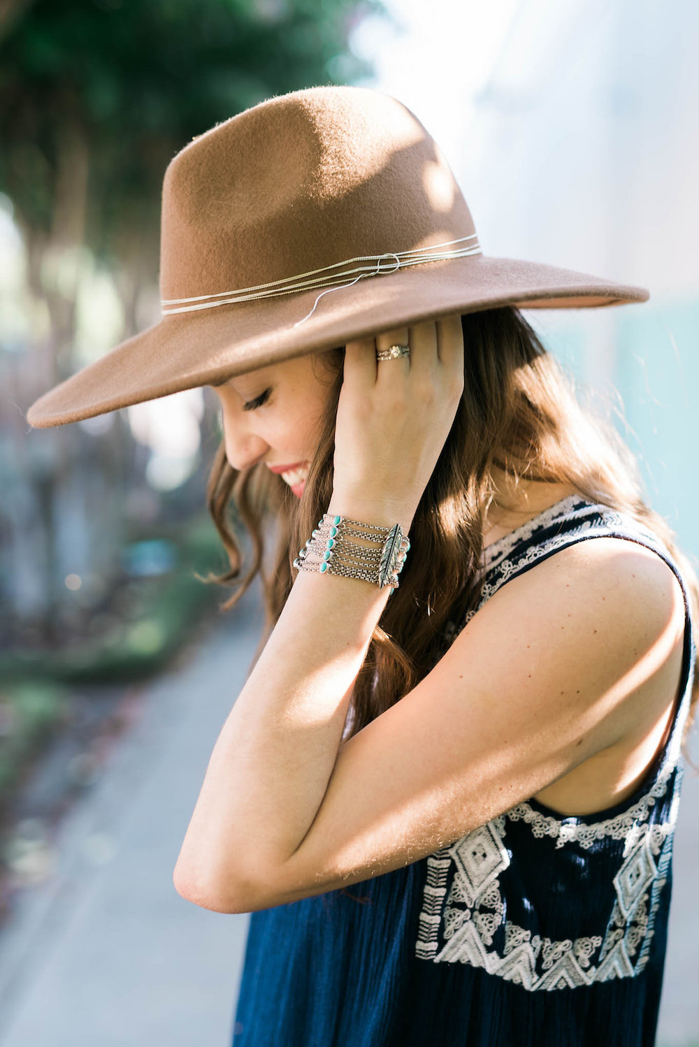 brown rancher hat and silver jewelry, silver lucky brand bracelet