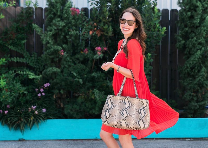 Maternity outfit inspiration with a red dress and snake print accessories.