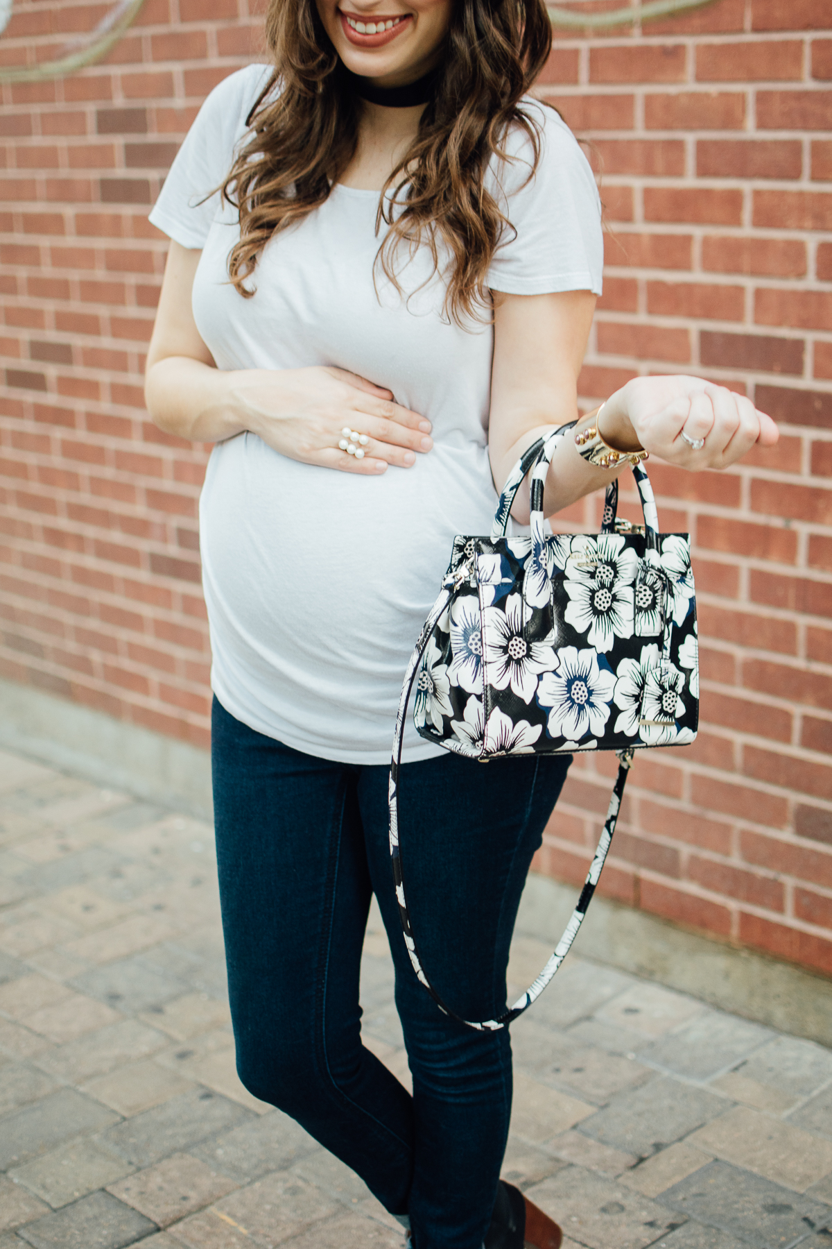 Texas fashion blogger Lone Star Looking Glass shares maternity outfit inspiration in a white tee, jeans and a Kate Spade Floral Handbag.
