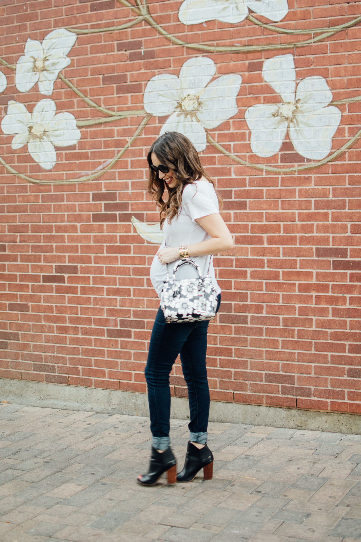 Texas fashion blogger Lone Star Looking Glass shares maternity outfit inspiration in a white tee, jeans and a Kate Spade Floral Handbag.