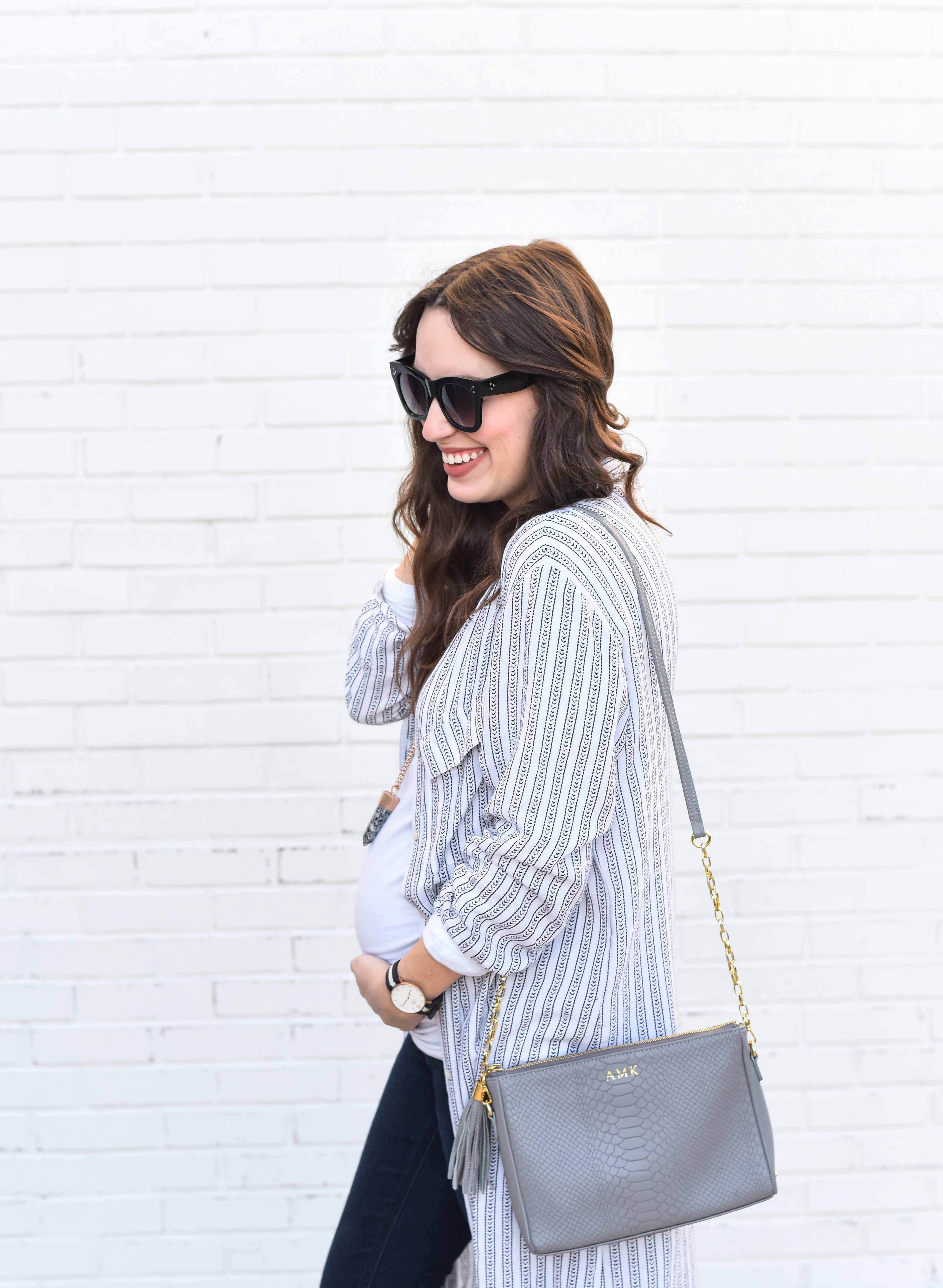 Fashion Blogger Alice Kerley styles a Planet Blue Button Down Dress over a tee and jeans for an easy maternity outfit. 