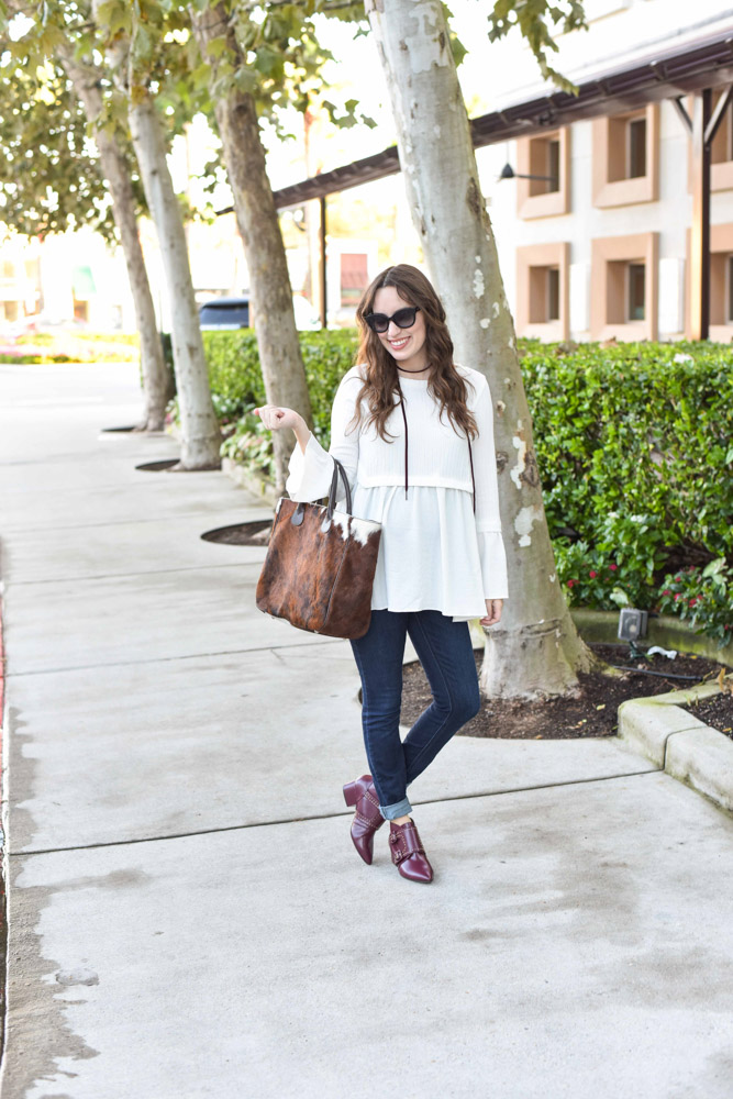 Texas fashion blogger styles a Pinkblush white peplum maternity top with a cowhide bag for fall. 