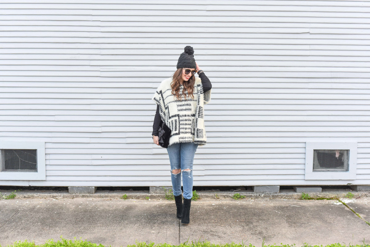 Houston fashion blogger styles sole society black ankle booties with a black and white poncho for a winter maternity style outfit.