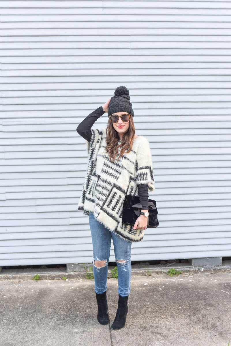 Houston fashion blogger styles sole society black ankle booties with a black and white poncho for a winter maternity style outfit.