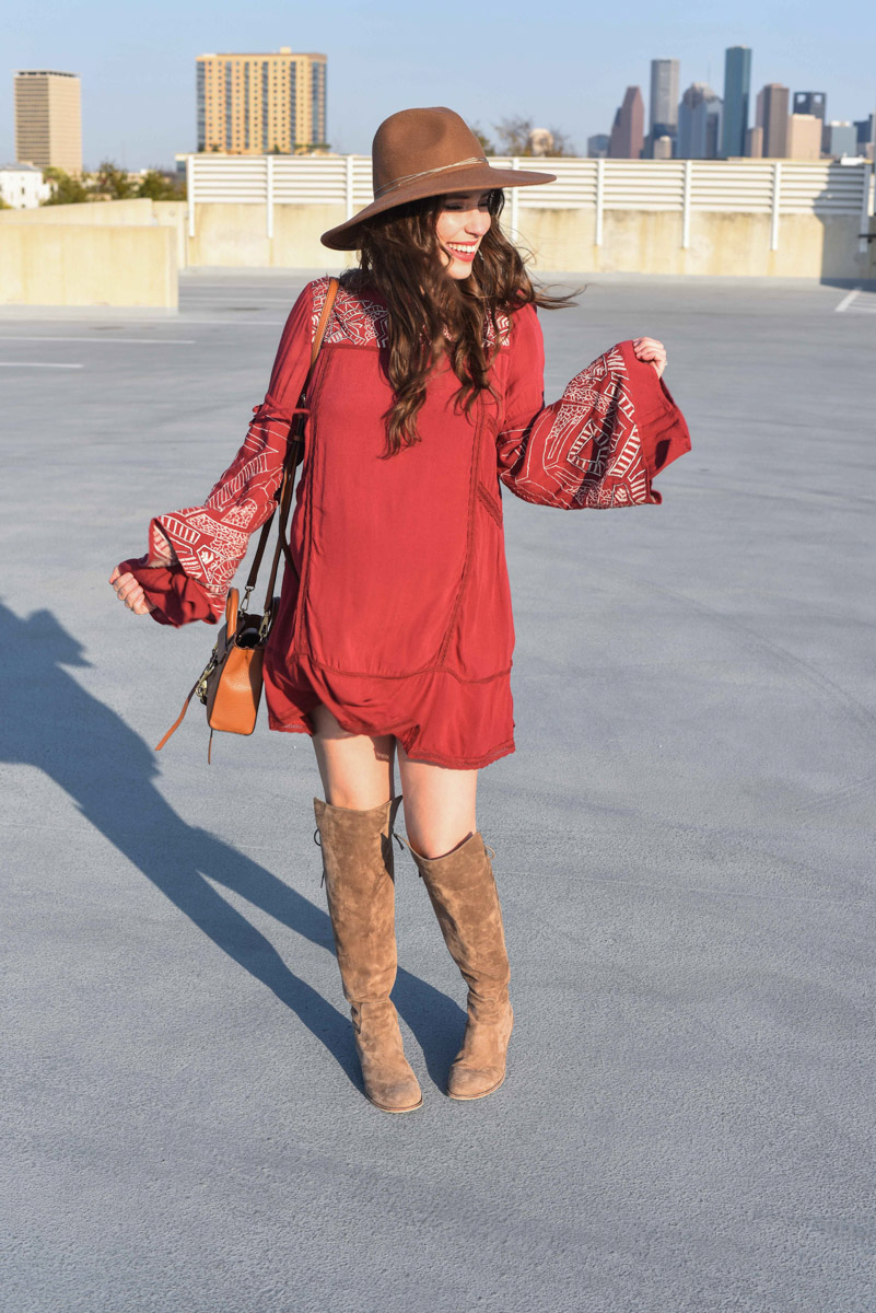 Houston fashion blogger Alice Kerley styles a Planet Blue bohemian red mini dress as a maternity dress with a pair of Elaine Turner suede over the knee boots.