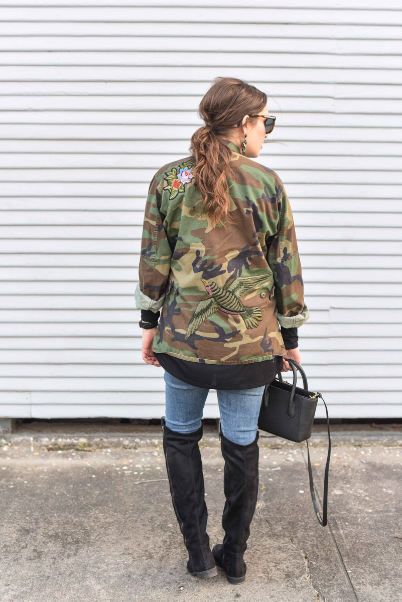 Houston fashion blogger styles an embroidered camo jacket from Planet Blue with skinny jeans, a black dagne dover tote and over the knee boots. 