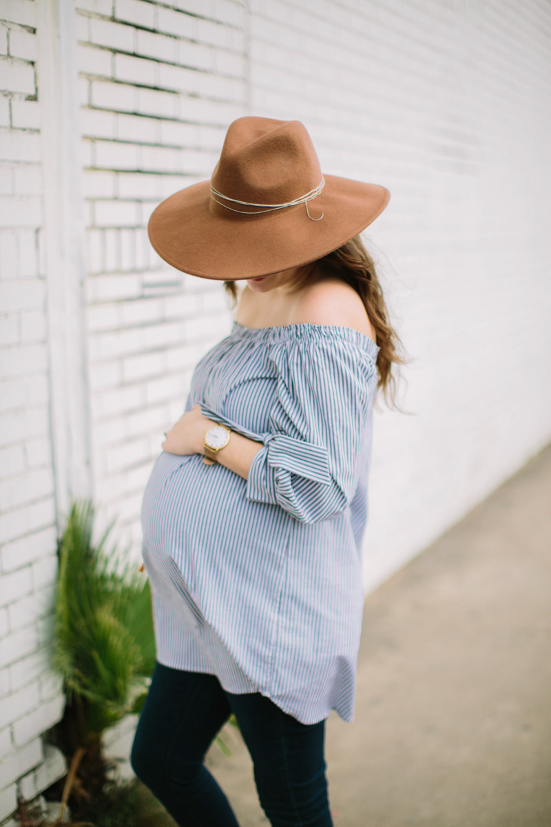 Houston fashion blogger styles an Audrey and Olive striped off the shoulder maternity shirt with a shore projects watch and free people rancher hat.