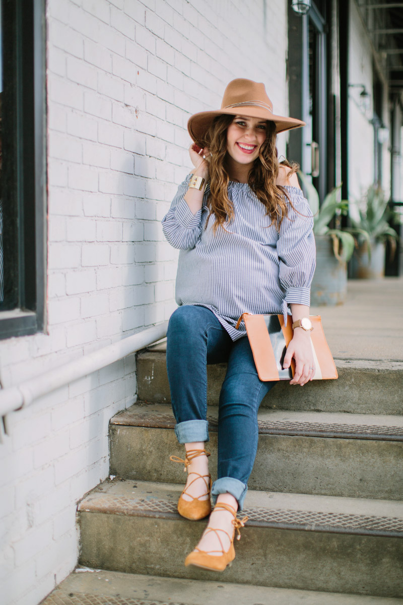 Houston fashion blogger styles a striped off the shoulder maternity top with maternity jeans, vionic lace up flats and a striped clare vivier clutch.