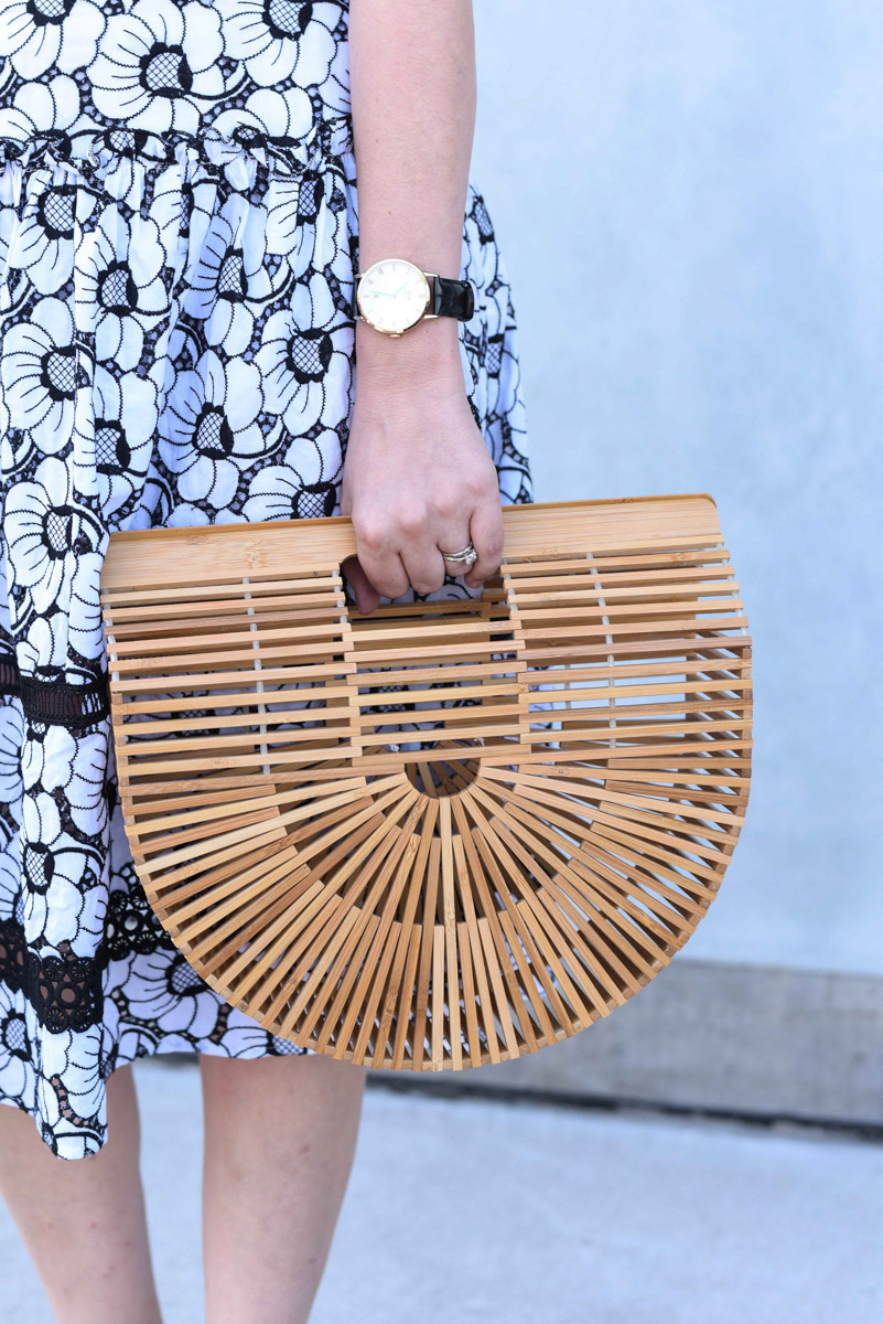 Houston blogger shares spring outfit inspiration in a black and white off the shoulder dress with a Cult Gaia bamboo bag.