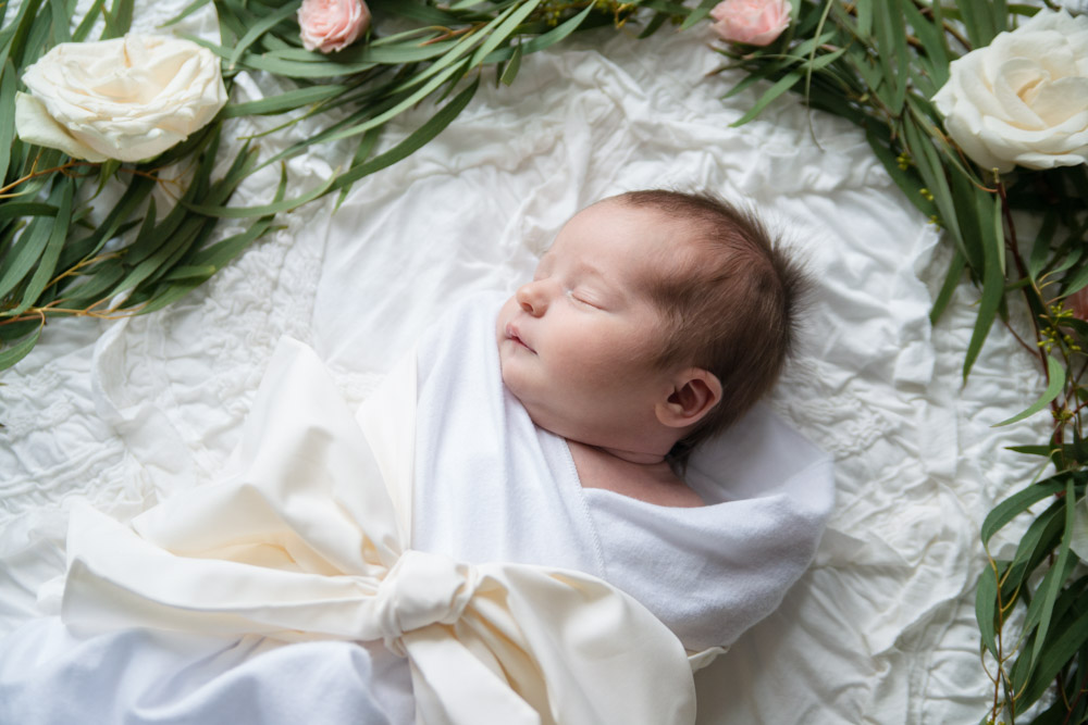 Newborn baby girl photography ideas: Beaufort bonnet bow swaddle and flower wreath.