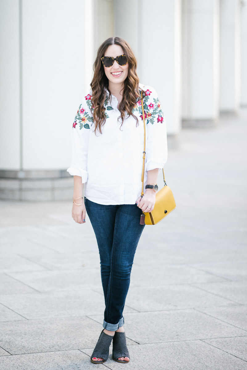 Embroidered White Button down styled with skinny jeans and the coach dinky bag in yellow.