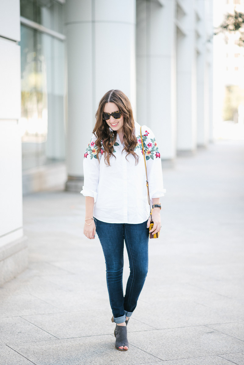 Embroidered White Button down styled with skinny jeans and the coach dinky bag in yellow.