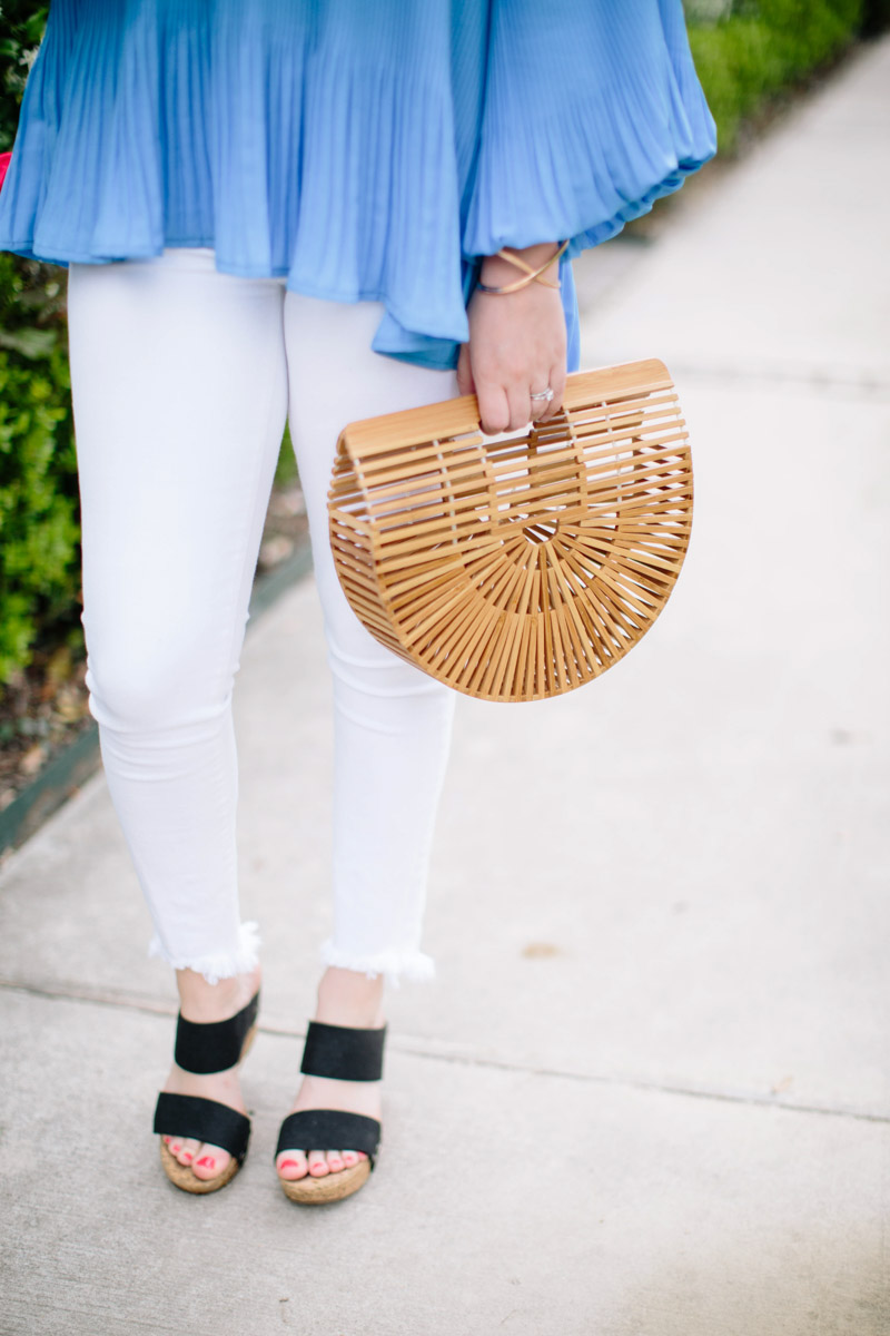 Houston blogger styles white jeans with a cult gaia bamboo bag. 
