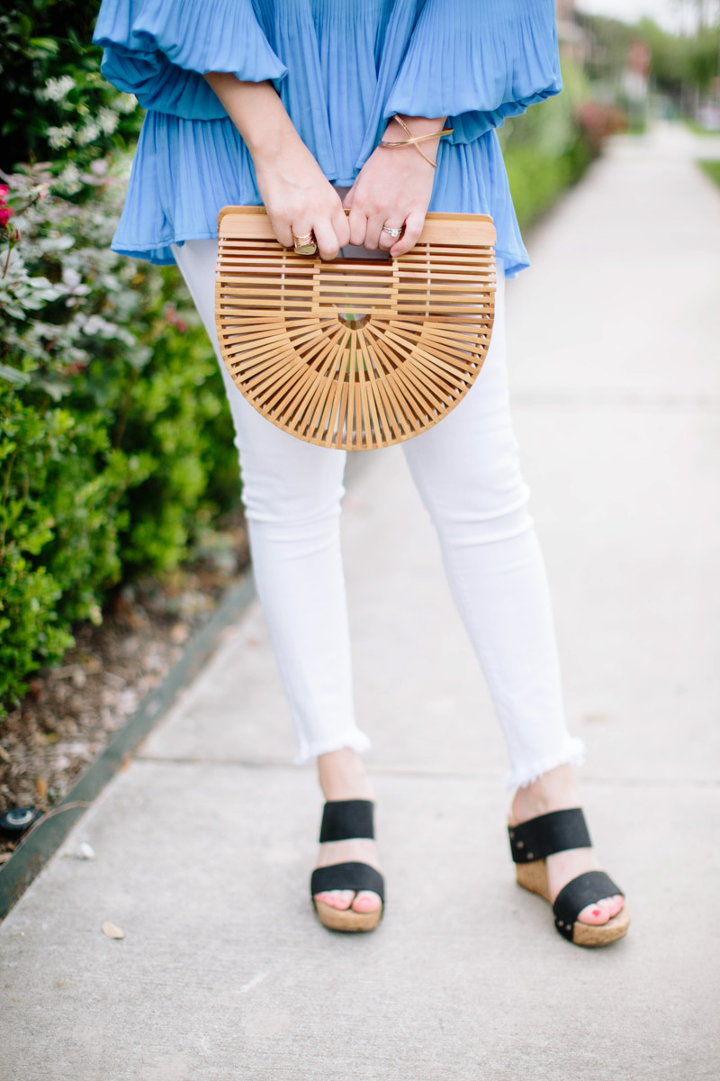Houston blogger styles white jeans with a cult gaia bamboo bag. 