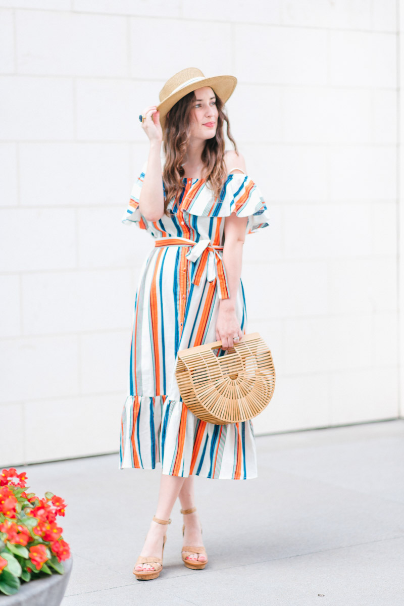 Houston blogger styles a striped moon river off the shoulder dress with a boater hat and Cult Gaia bag.