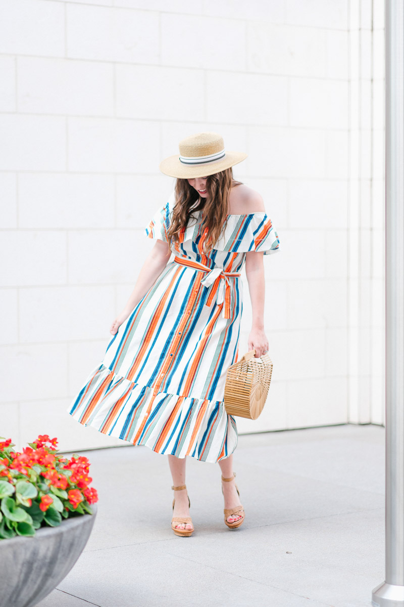 Houston blogger styles a striped moon river off the shoulder dress with a boater hat and Cult Gaia bag.