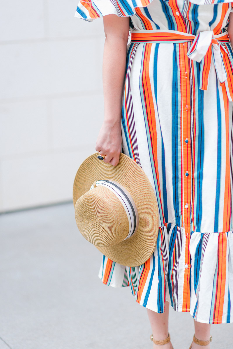 Houston blogger styles a striped moon river off the shoulder dress with a boater hat