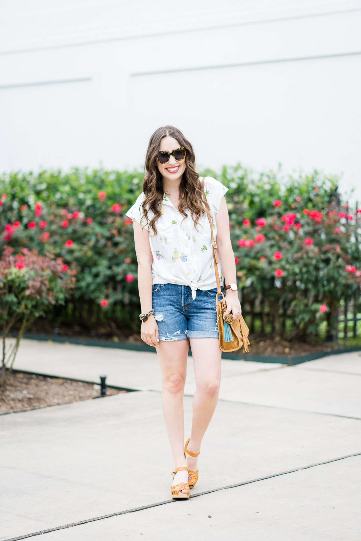 Houston blogger styles an easy summer look in an Anthropologie cactus button down, levi shorts, swedish hasbeens and a fossil handbag.
