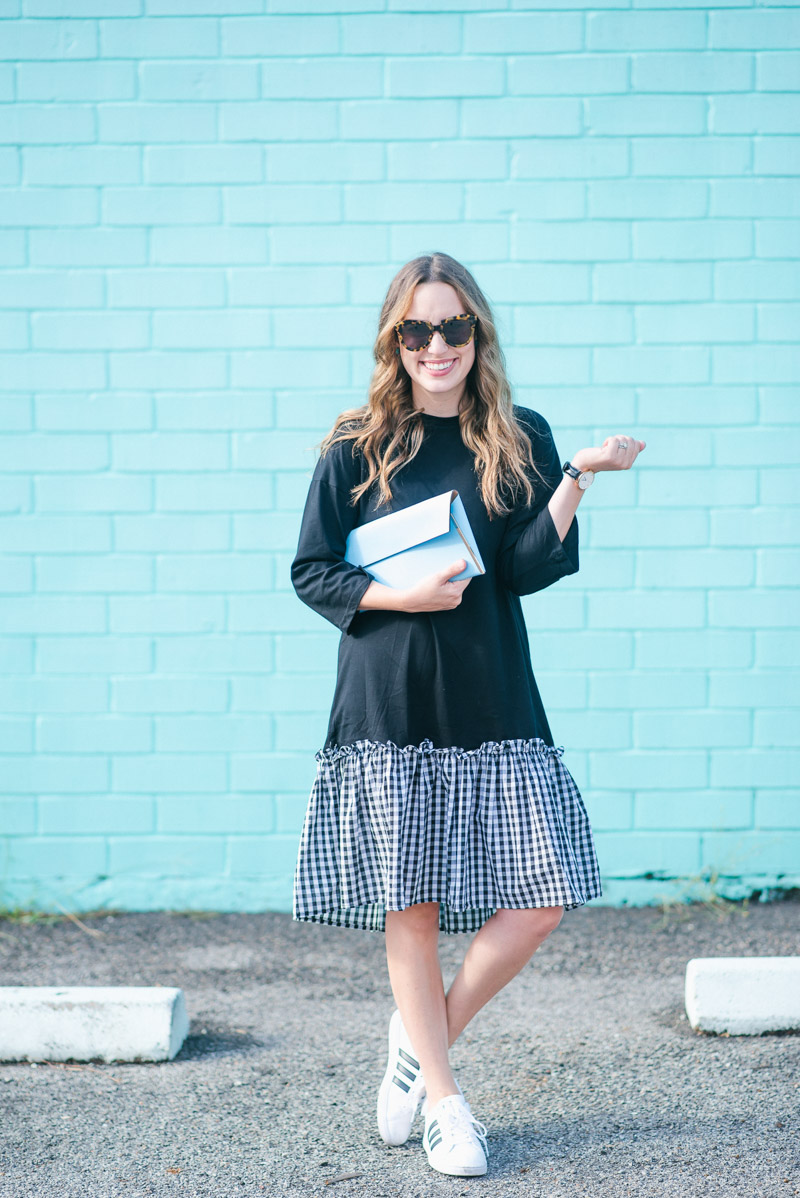 Casual and cool in a black tshirt dress with a gingham hem & addidas sneakers.