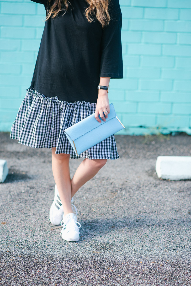 Casual and cool in a black tshirt dress with a gingham hem & addidas sneakers.