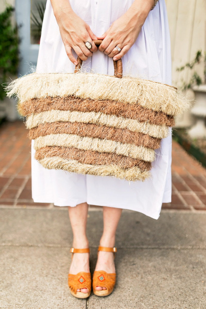 Texas blogger styles a white chichwish midi dress with a straw basket for summer.