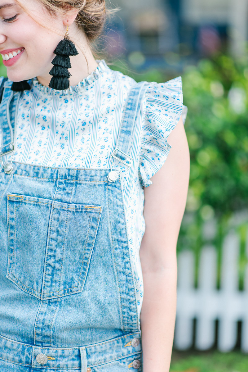 A ruffle sleeve top with distressed overalls.