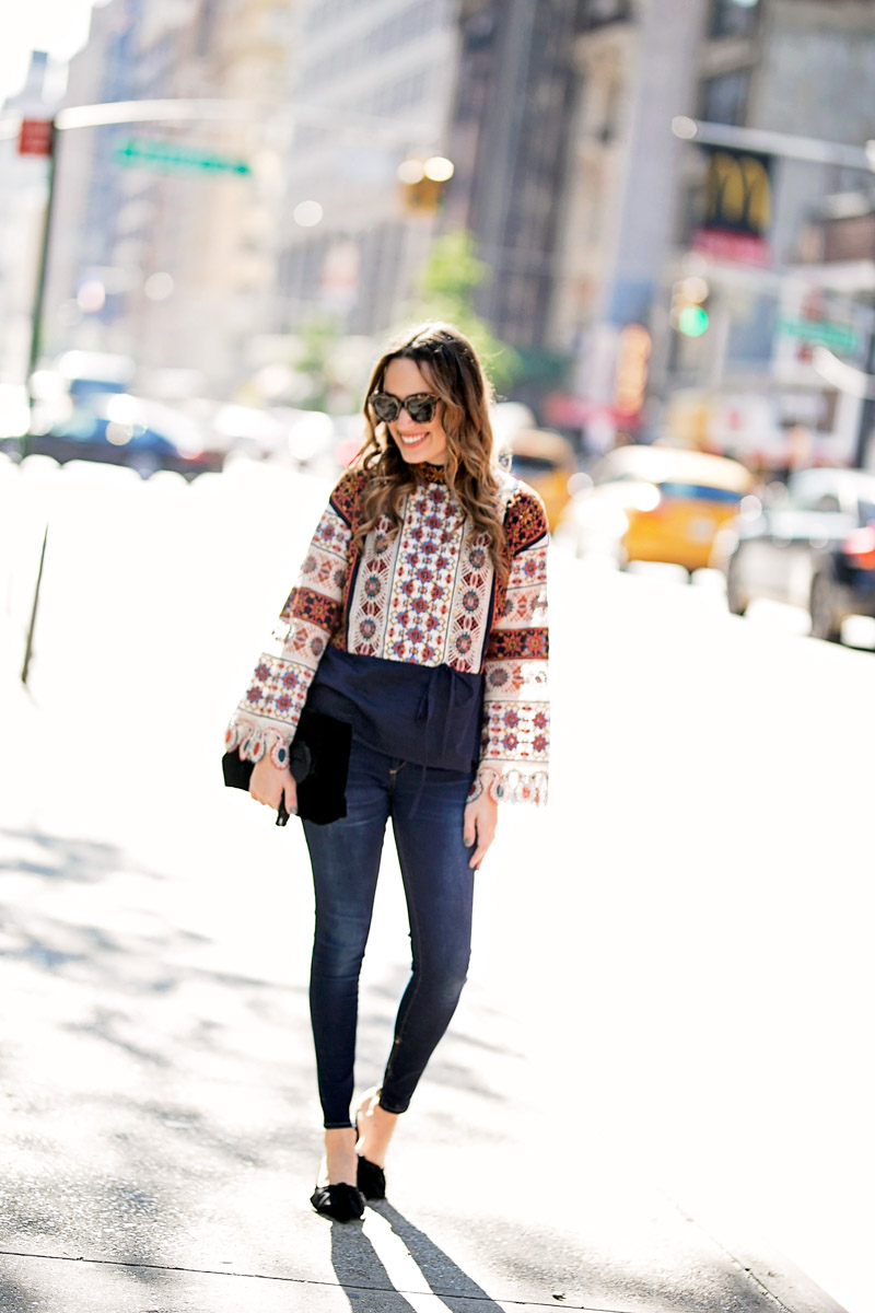Tory Burch Boho Top paired with velvet bow heels and skinny jeans during New York Fashion Week 2018.