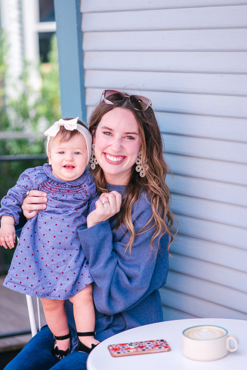 Mother Daughter Duo in a Boden Mini Polka Dot Dress, A goodnight Macaron Blue Sweater, and Lisi Lerch ginger Earrings.