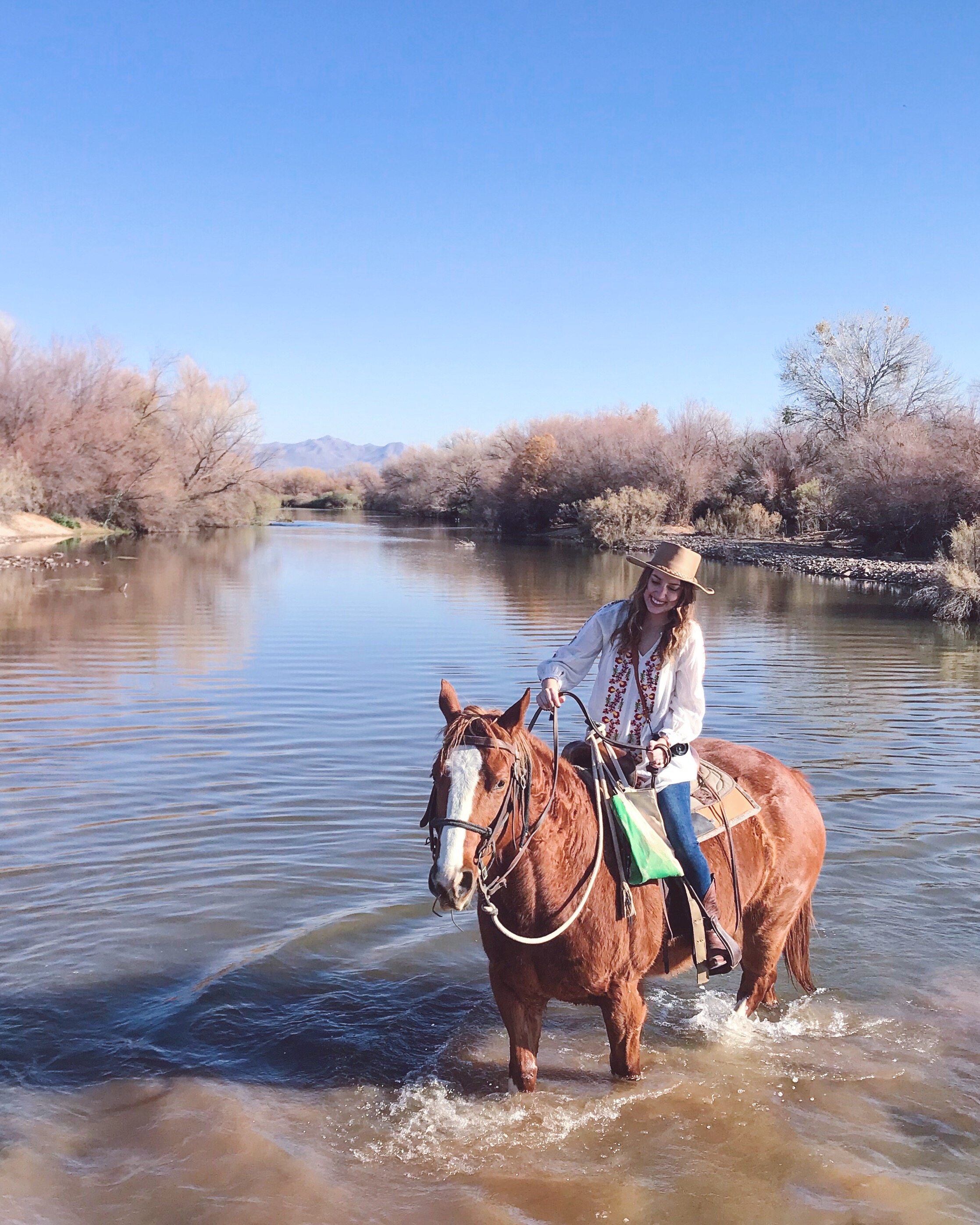Phoenix Travel Guide featured by top Houston travel blog, Lone Star Looking Glass: image of a woman horse back riding in the river