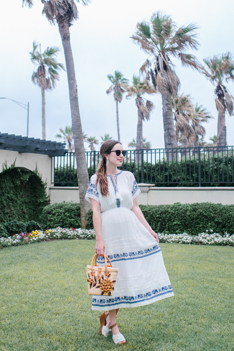 Houston fashion blogger styles a blue and white embroidered midi dress from Evereve. 