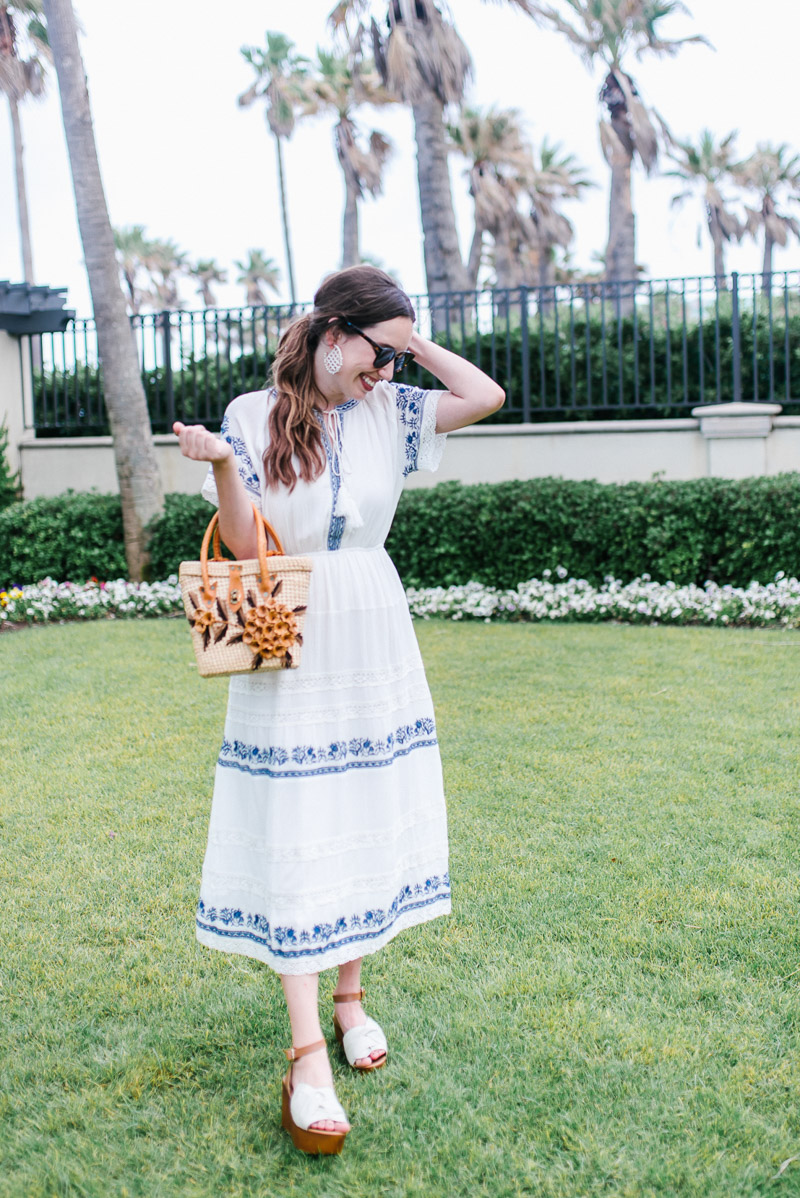 Houston fashion blogger styles a blue and white embroidered midi dress from Evereve. 