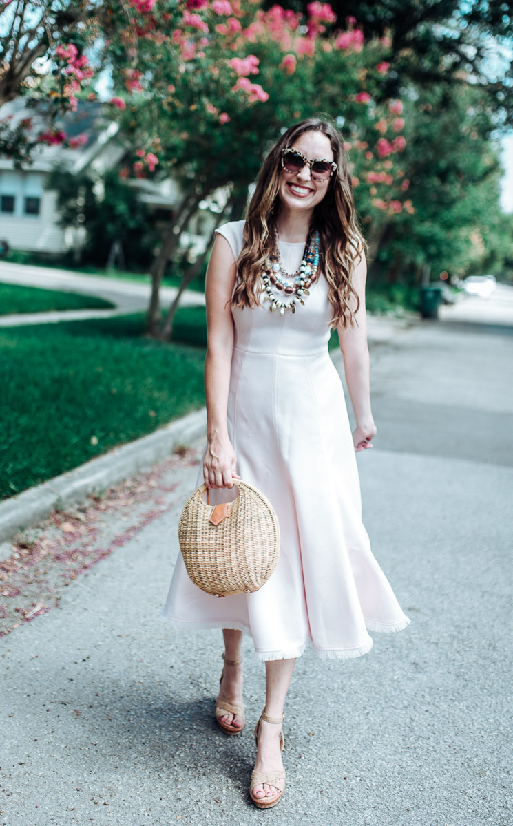 Houston fashion blogger styles an Eliza J pink fringe hem midi dress.