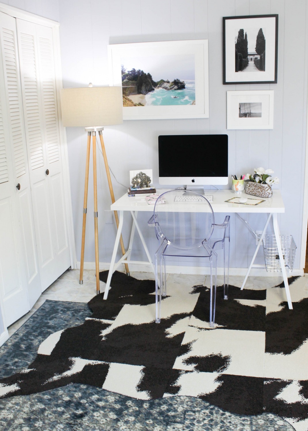 Living room office space inspiration with a DIY cowhide rug and a travel photo gallery wall from FLOR and Framebridge.