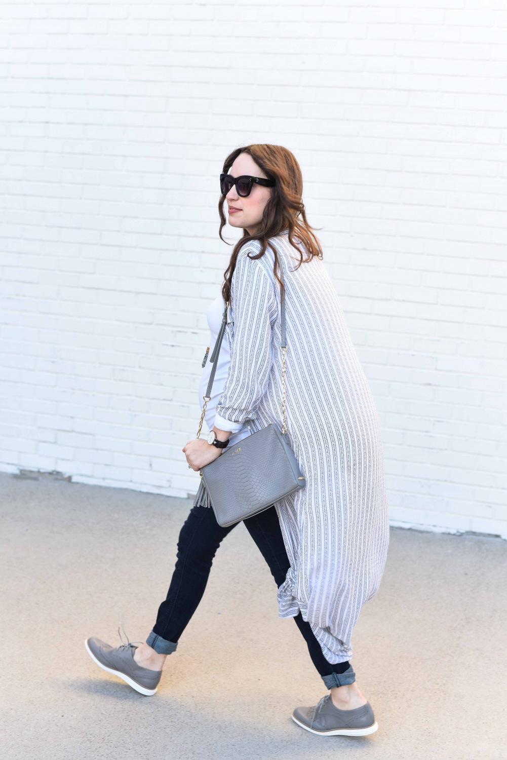 Fashion Blogger Alice Kerley styles a Planet Blue Button Down Dress over a tee and jeans for an easy maternity outfit.