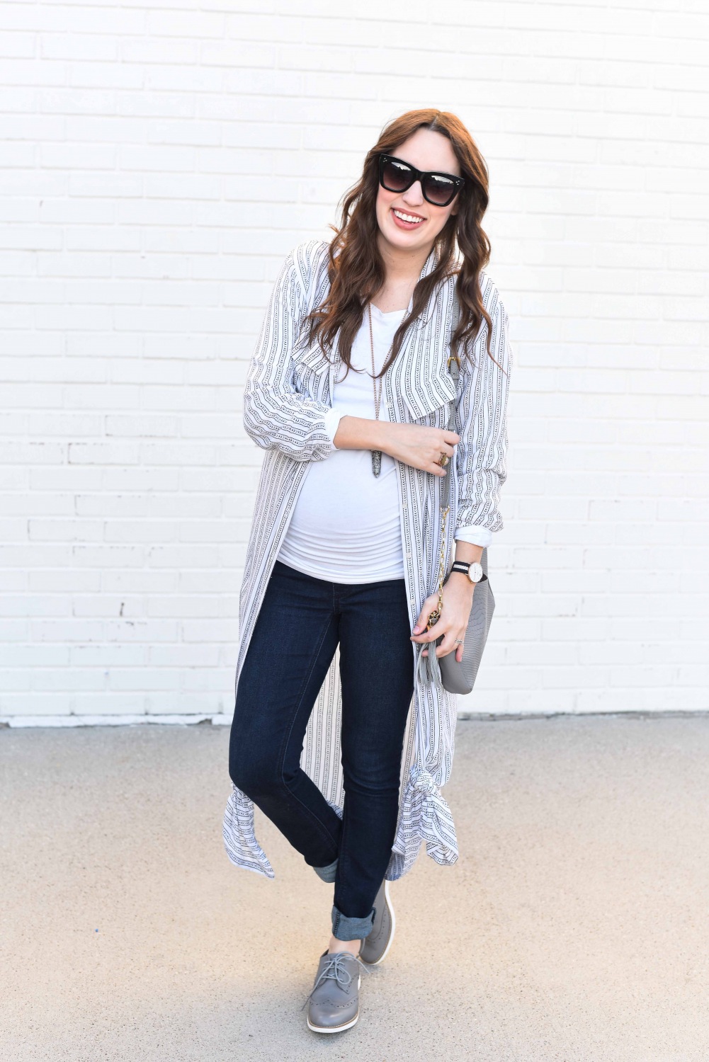 Fashion Blogger Alice Kerley styles a Planet Blue Button Down Dress over a tee and jeans for an easy maternity outfit.