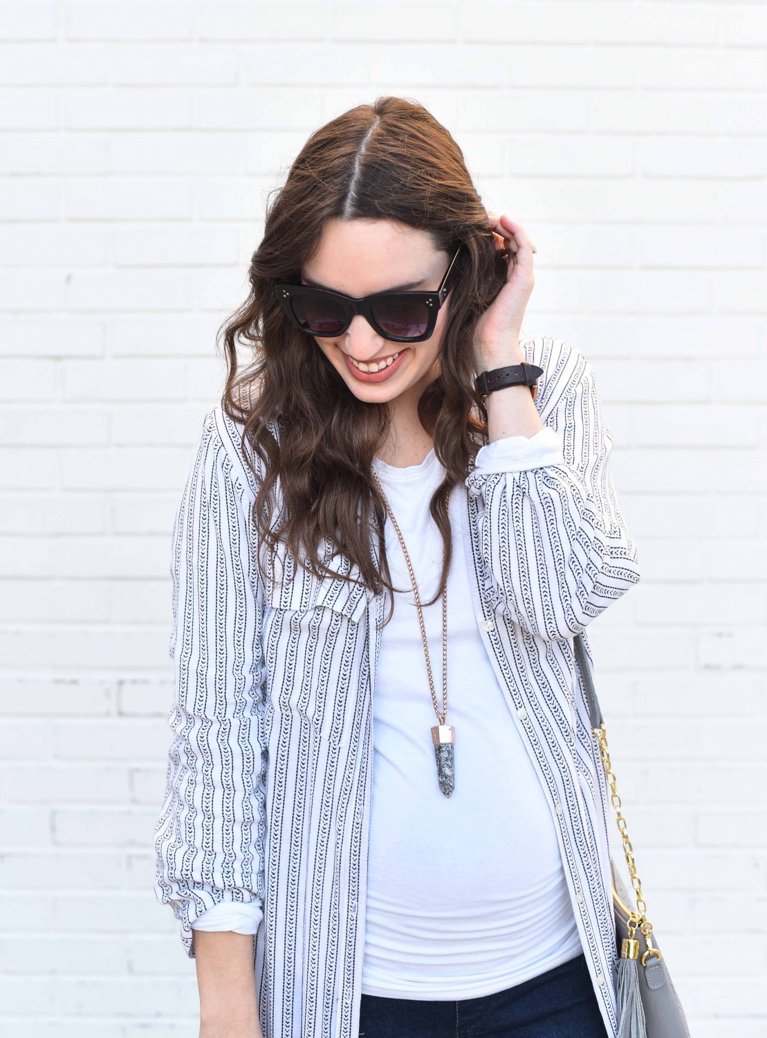 Fashion Blogger Alice Kerley styles a Planet Blue Button Down Dress over a tee and jeans for an easy maternity outfit.