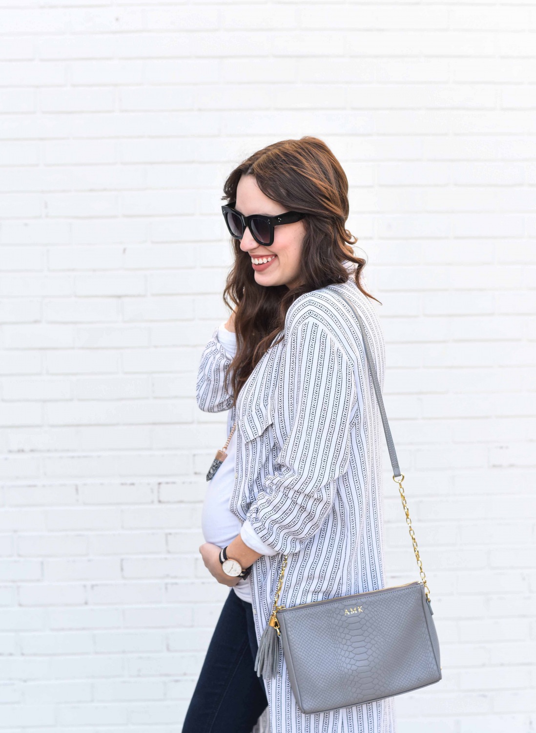 Fashion Blogger Alice Kerley styles a Planet Blue Button Down Dress over a tee and jeans for an easy maternity outfit.