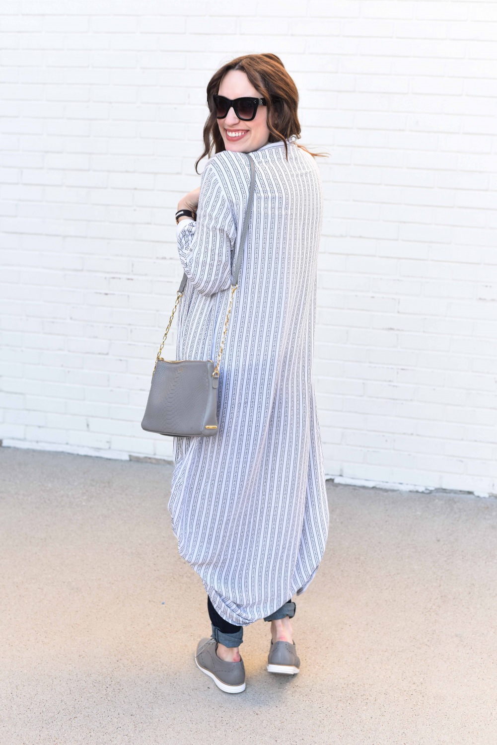 Fashion Blogger Alice Kerley styles a Planet Blue Button Down Dress over a tee and jeans for an easy maternity outfit.