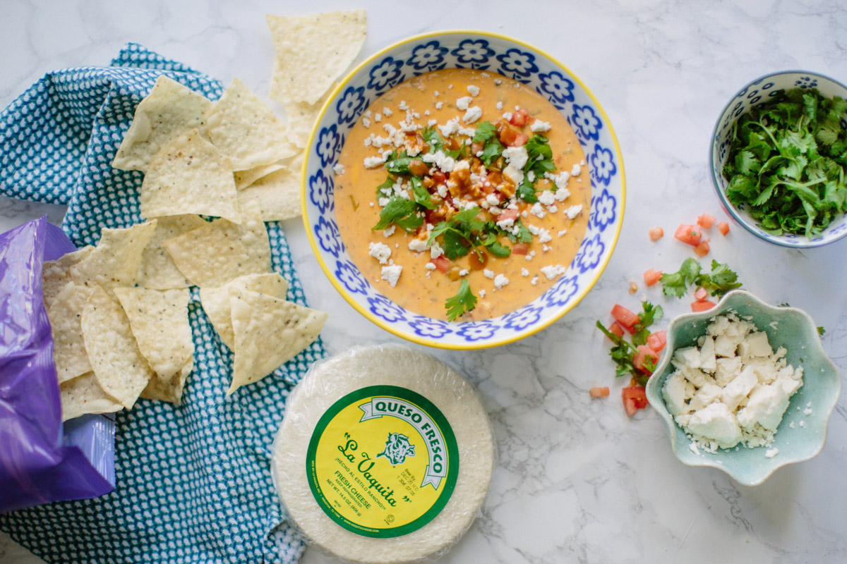 Texas style queso recipe: cheese dip with green chilis, hot sauce and la vaquita cheese.  | Texas Queso Recipe featured by top Houston life and style blog, Lone Star Looking Glass