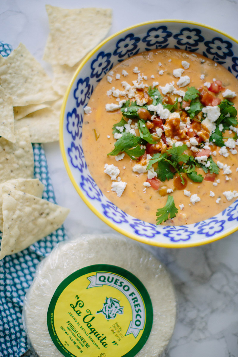 Texas style queso recipe: cheese dip with green chilis, hot sauce and la vaquita cheese.  | Texas Queso Recipe featured by top Houston life and style blog, Lone Star Looking Glass