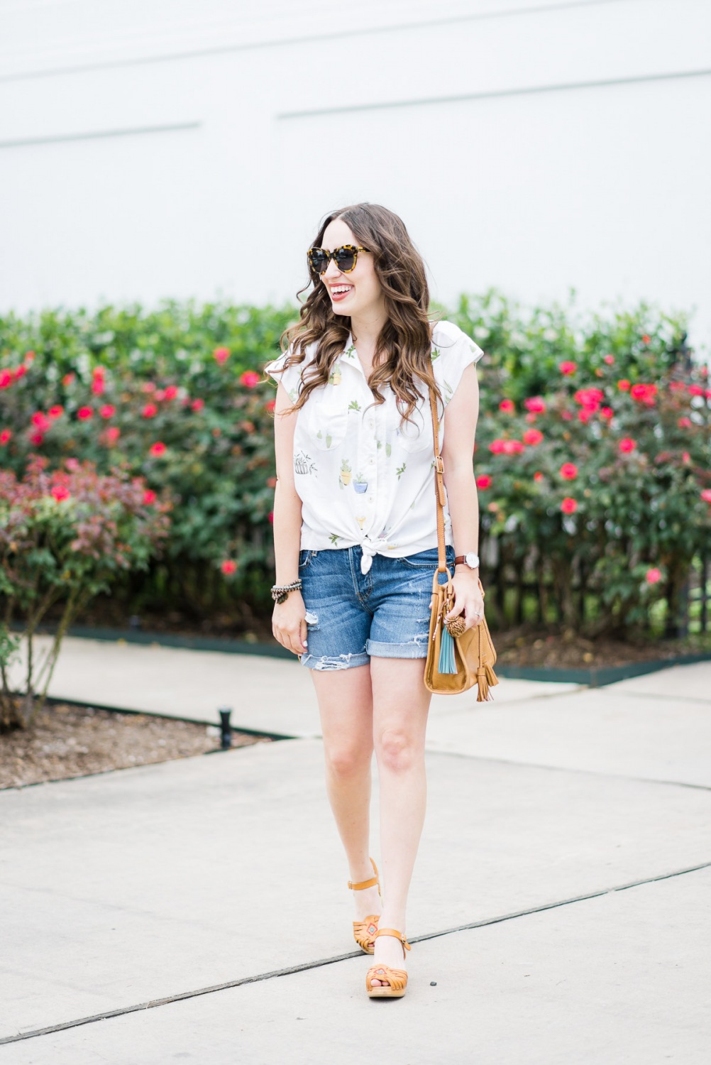 Houston blogger styles an easy summer look in an Anthropologie cactus button down, levi shorts, swedish hasbeens and a fossil handbag.