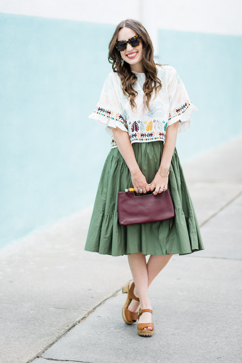 Best Mexican Restaurants in Houston featured by top Houston blog Lone Star Looking Glass; Image of a woman wearing a boho embroidered crop top with a green midi skirt.
