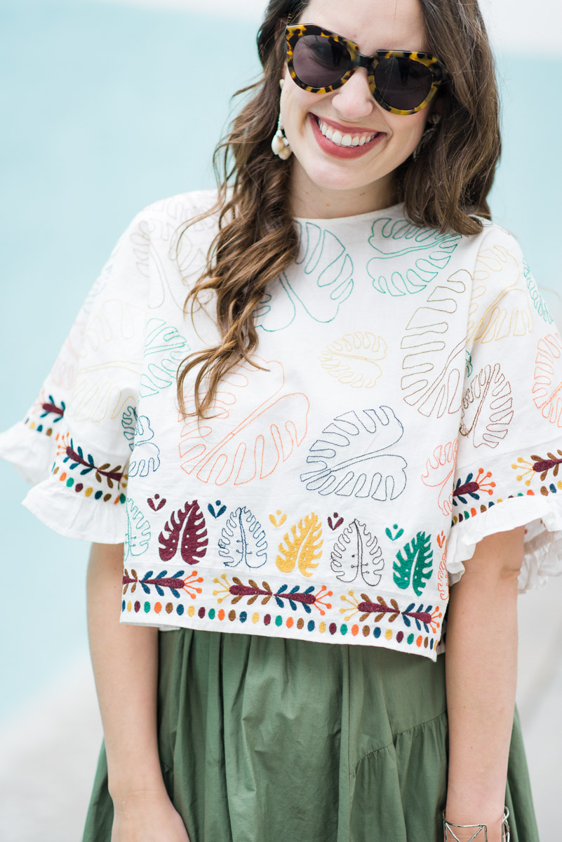 Best Mexican Restaurants in Houston featured by top Houston blog Lone Star Looking Glass; Image of a woman wearing a boho embroidered crop top with a green midi skirt.