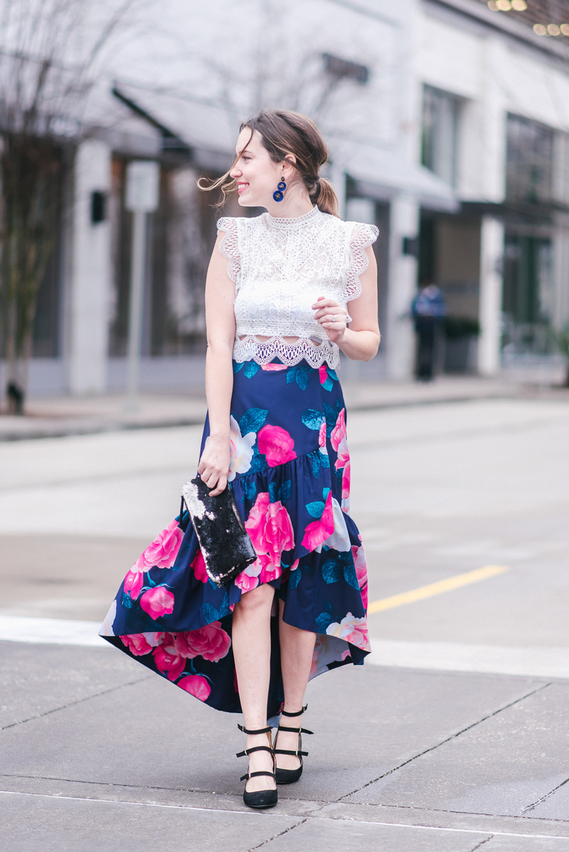 Eliza J Skirt styled for Valentine’s Day by top US fashion blog, Lone Star Looking Glass: image of a woman wearing a floral Eliza J skirt, Chicwish white crochet top, Stella& Dot sequin clutch, and Bella Vita pumps