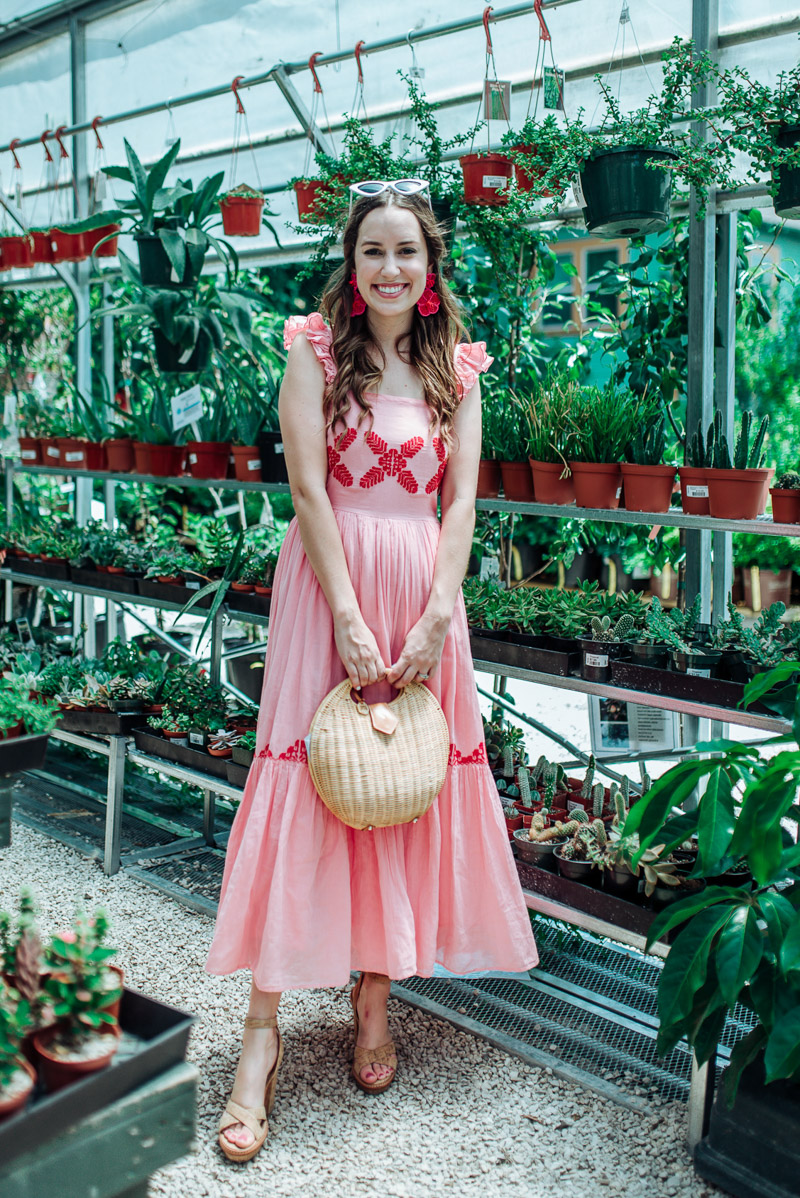 Pink Midi Dress featured by top US fashion blog Lone Star Looking Glass; Image of a woman wearing a pink embroidered midi dress by Carolina K.