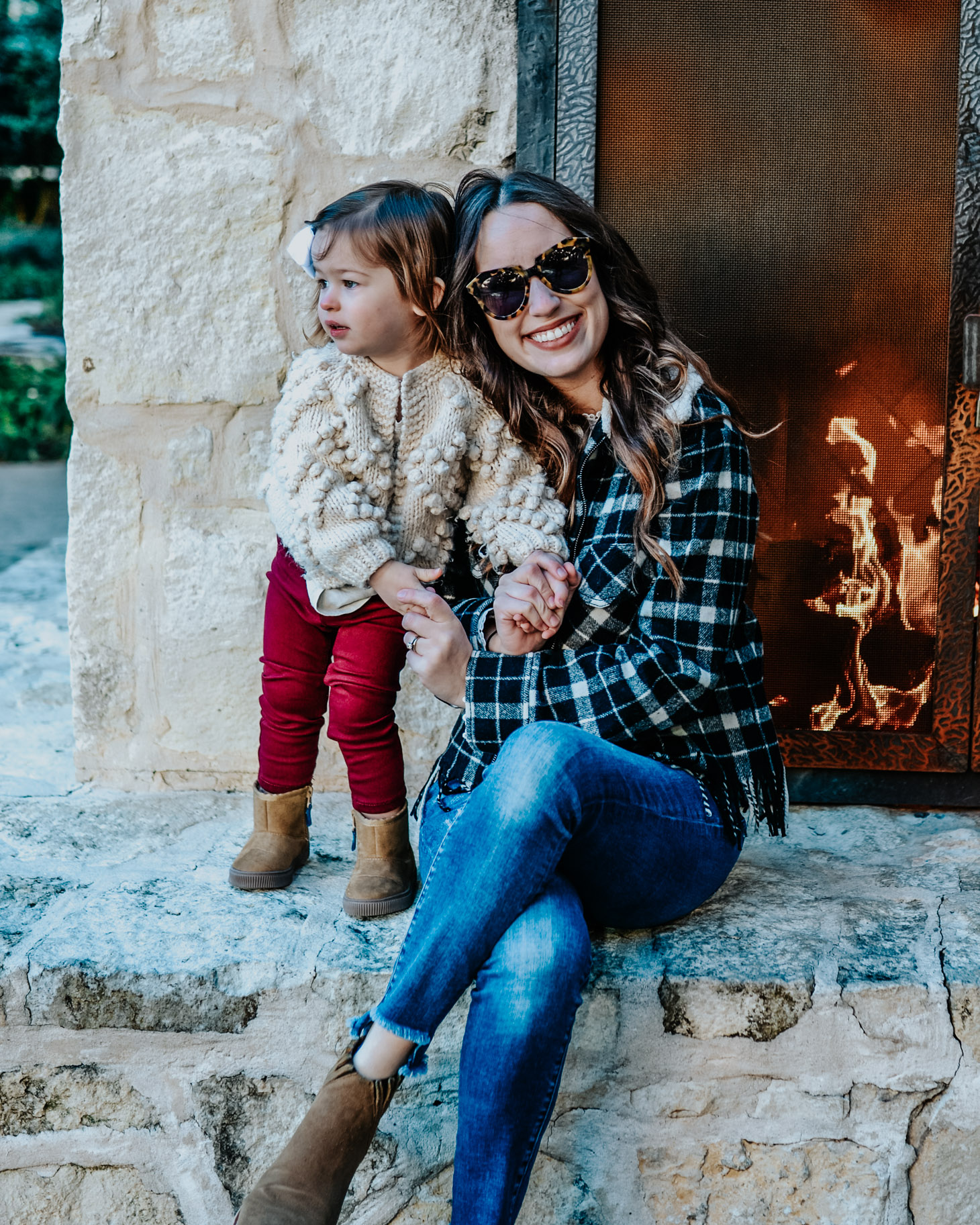 San Antonio in Winter featured by top US travel blog Lone Star Looking Glass; Image of a mother and daughter sitting by the fire.