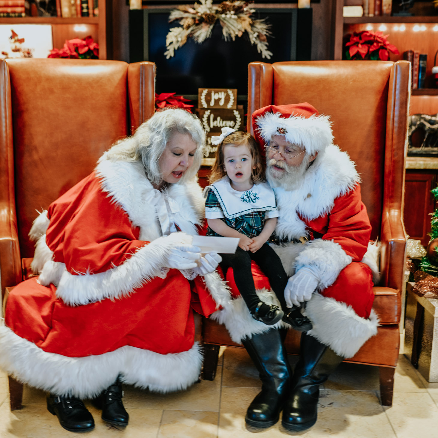 San Antonio in Winter featured by top US travel blog Lone Star Looking Glass; Image of child with Santa Claus and Mrs Claus